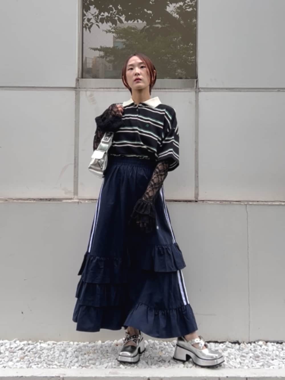 ブルー系のスカート、ブラック系のTシャツ/カットソー、ブラック系のポロシャツを着用したレディースの夏コーディネートの2枚目の写真