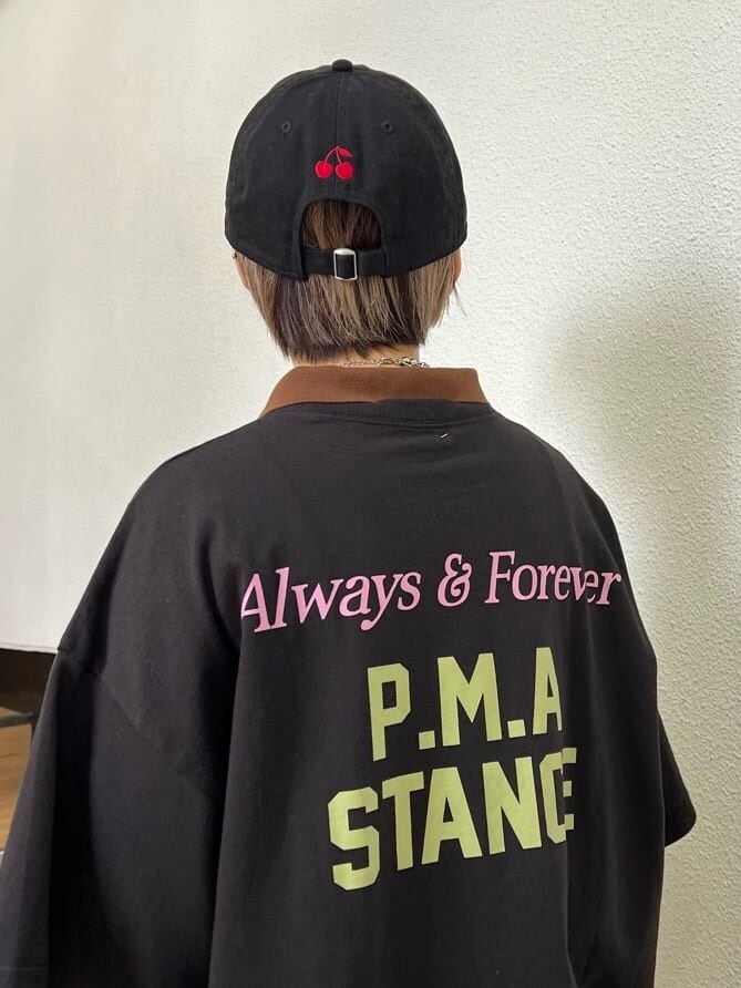 ブラック系のTシャツ/カットソー、パープル系のワンピース、ブラック系のキャップを着用したレディースの夏コーディネートの7枚目の写真