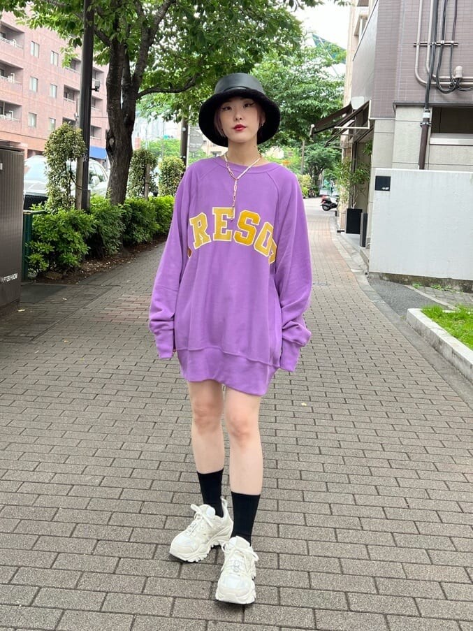 ブラック系のデニムパンツ、ホワイト系のスニーカー、パープル系のスウェットを着用したレディースの夏コーディネートの2枚目の写真