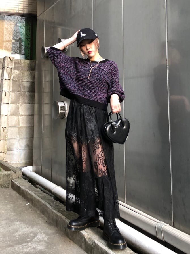 ブラック系のブーツ、ブラック系のデニムパンツ、ブラック系のショルダーバッグを着用したレディースの春コーディネートの4枚目の写真