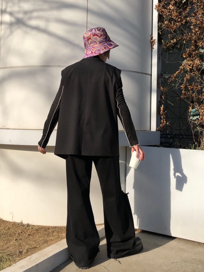 ブラック系のベスト、ブラック系のデニムパンツ、ブラック系のTシャツ/カットソーを着用したレディースの春コーディネートの4枚目の写真