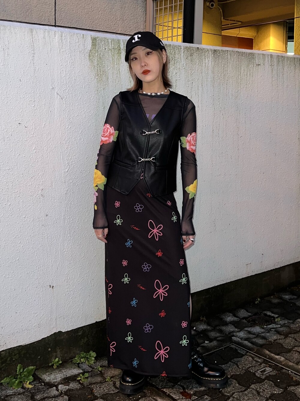 ブラック系のTシャツ/カットソー、ブラック系のベスト、ブラック系のスカートを着用したレディースの春コーディネートの4枚目の写真