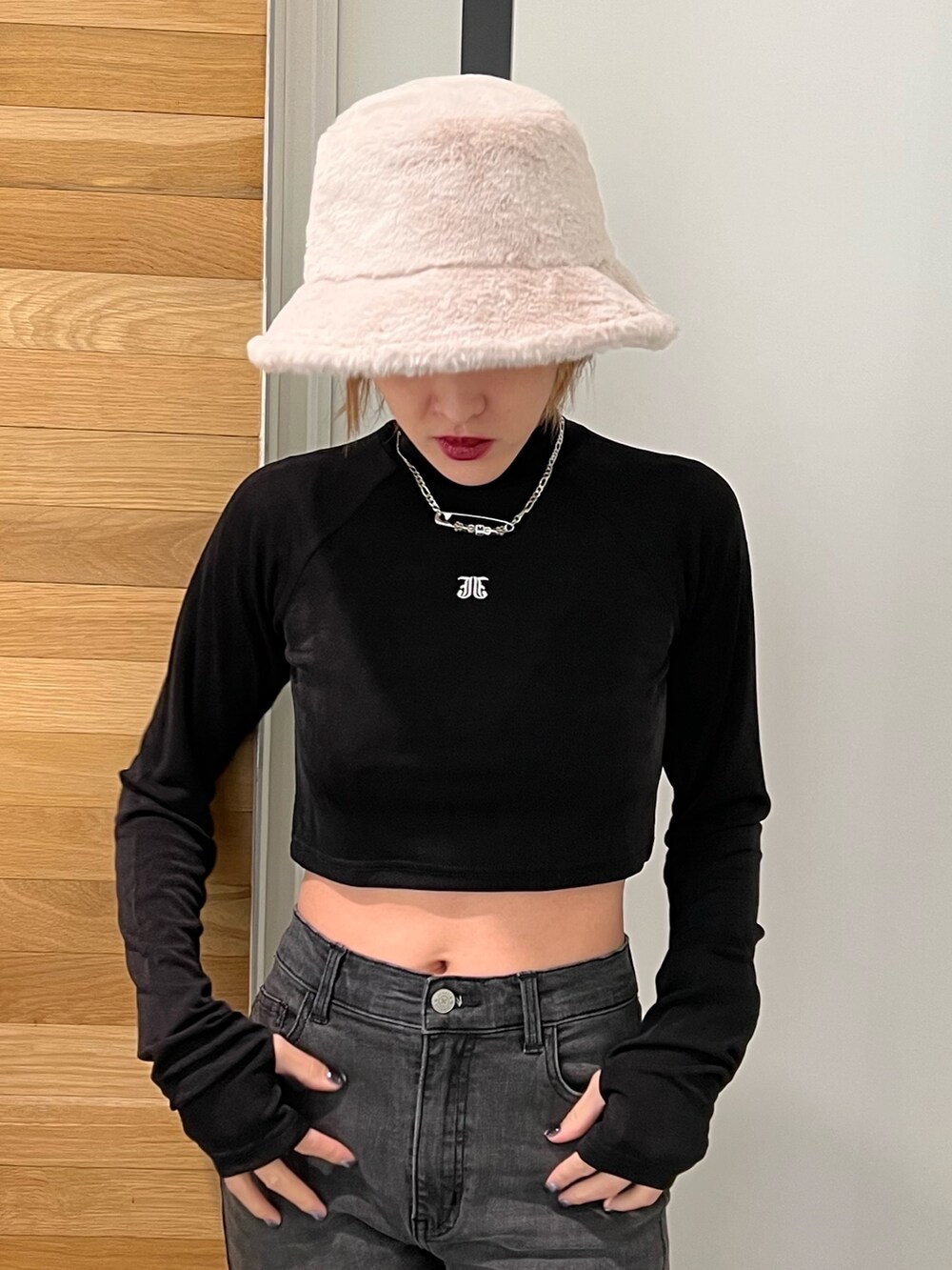 ブラック系のデニムパンツ、ブラック系のTシャツ/カットソー、ベージュ系のワンピースを着用したレディースの秋コーディネートの6枚目の写真