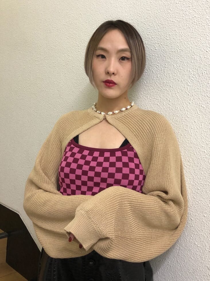 ベージュ系のトレンチコート、ブラック系のその他パンツ、ブラック系のブーツを着用したレディースの春コーディネートの6枚目の写真