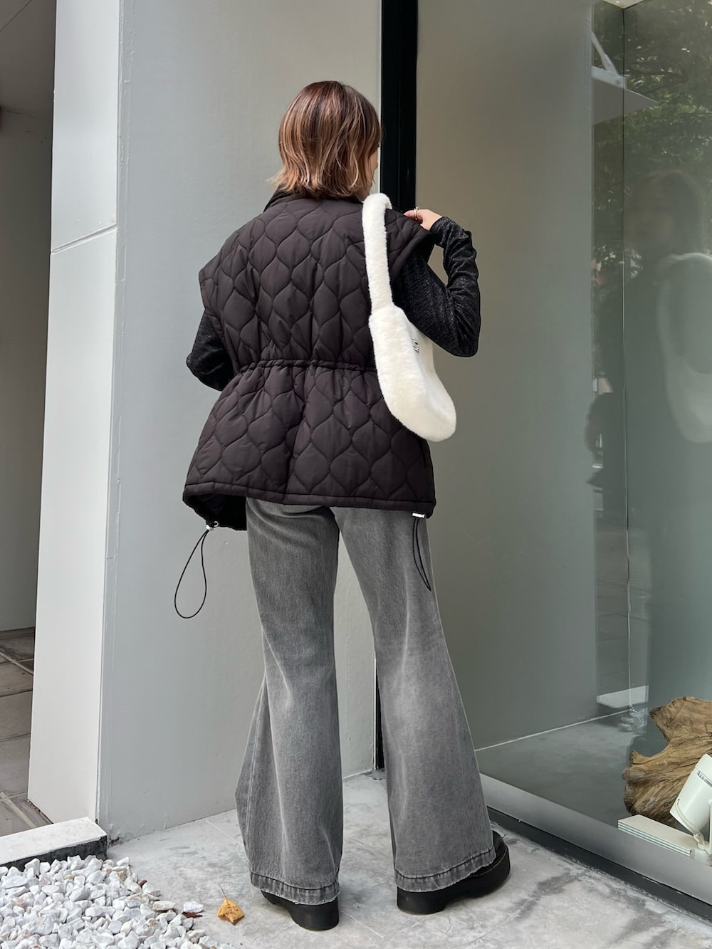 ブラック系のデニムパンツ、ブラック系のTシャツ/カットソー、ブラック系のその他アウターを着用したレディースの冬コーディネートの3枚目の写真