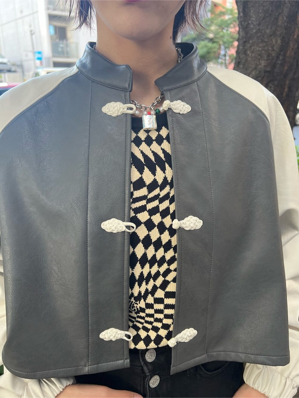 ブラック系のニット/セーター、ホワイト系のスニーカー、ブラック系のデニムパンツを着用したレディースの秋コーディネートの7枚目の写真