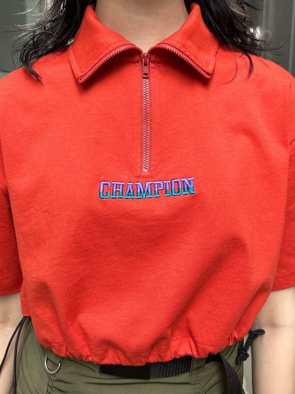 レッド系のTシャツ/カットソー、グリーン系のスカート、ベージュ系のその他パンツを着用したレディースの春コーディネートの5枚目の写真