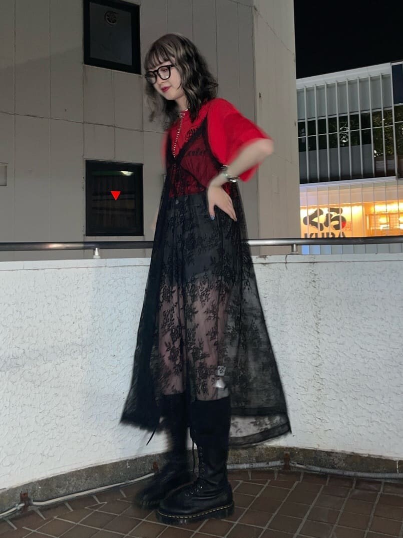 ブラック系のブーツ、ブラック系のデニムパンツ、ブラック系のワンピースを着用したレディースの春コーディネートの3枚目の写真