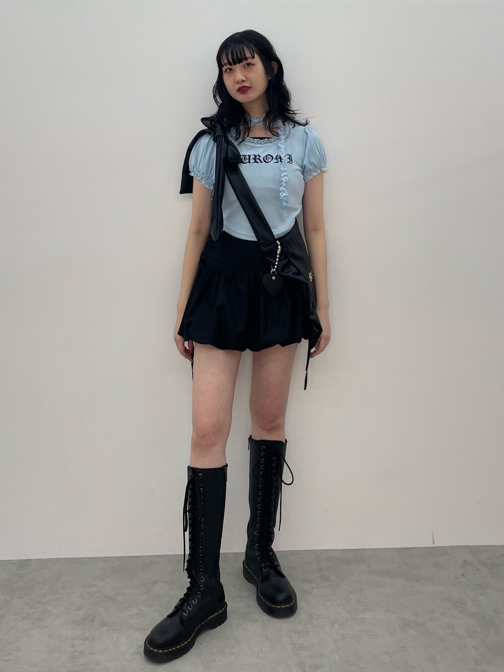 ブルー系のTシャツ/カットソー、ブラック系のトートバッグ、ブラック系のスカートを着用したレディースの春コーディネートの2枚目の写真