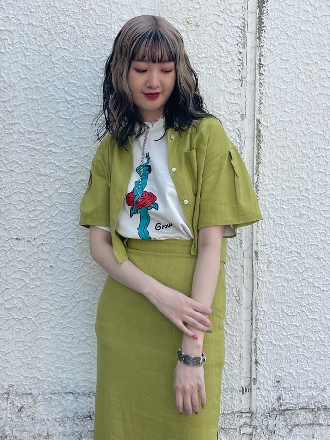 ブラック系のブーツ、グリーン系のシャツ/ブラウス、ホワイト系のTシャツ/カットソーを着用したレディースの春コーディネートの4枚目の写真