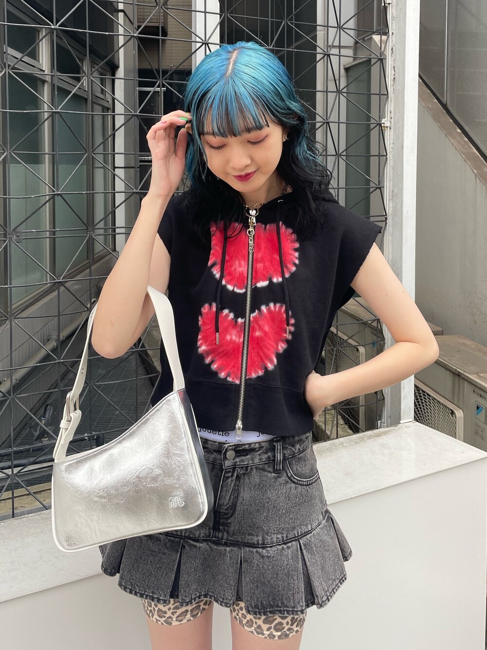 ブラック系のタンクトップ、ブラック系のデニムパンツ、シルバー系のサンダルを着用したレディースの春コーディネートの4枚目の写真