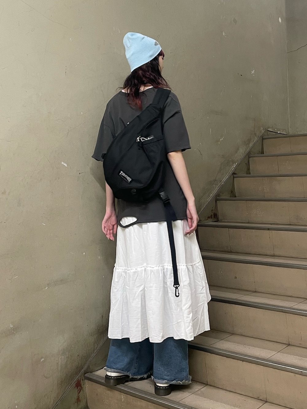 ブラック系のTシャツ/カットソー、ホワイト系のスカート、ブラック系のバックパック/リュックを着用したレディースの夏コーディネートの3枚目の写真