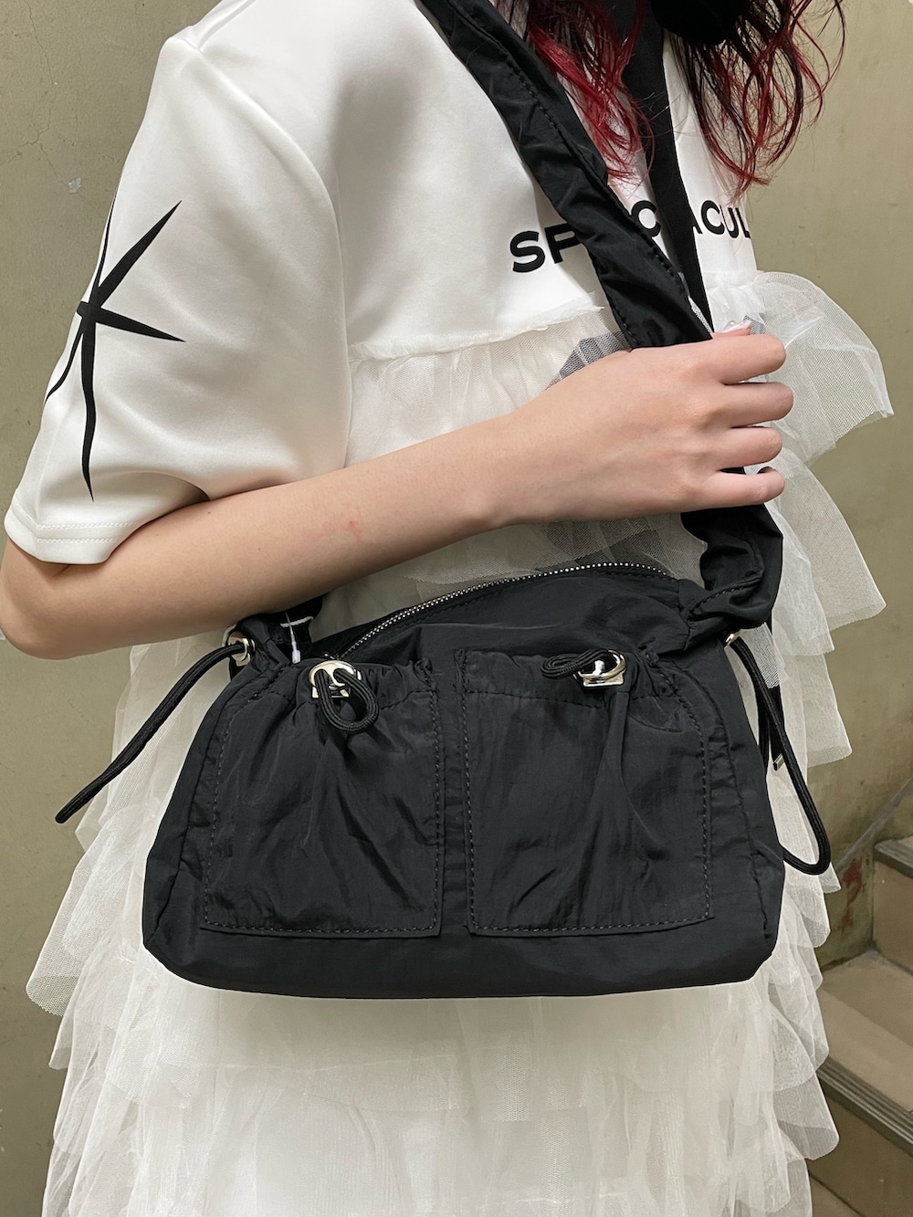 ホワイト系のワンピース、ブラック系のショルダーバッグ、ブラック系のブーツを着用したレディースの春コーディネートの9枚目の写真