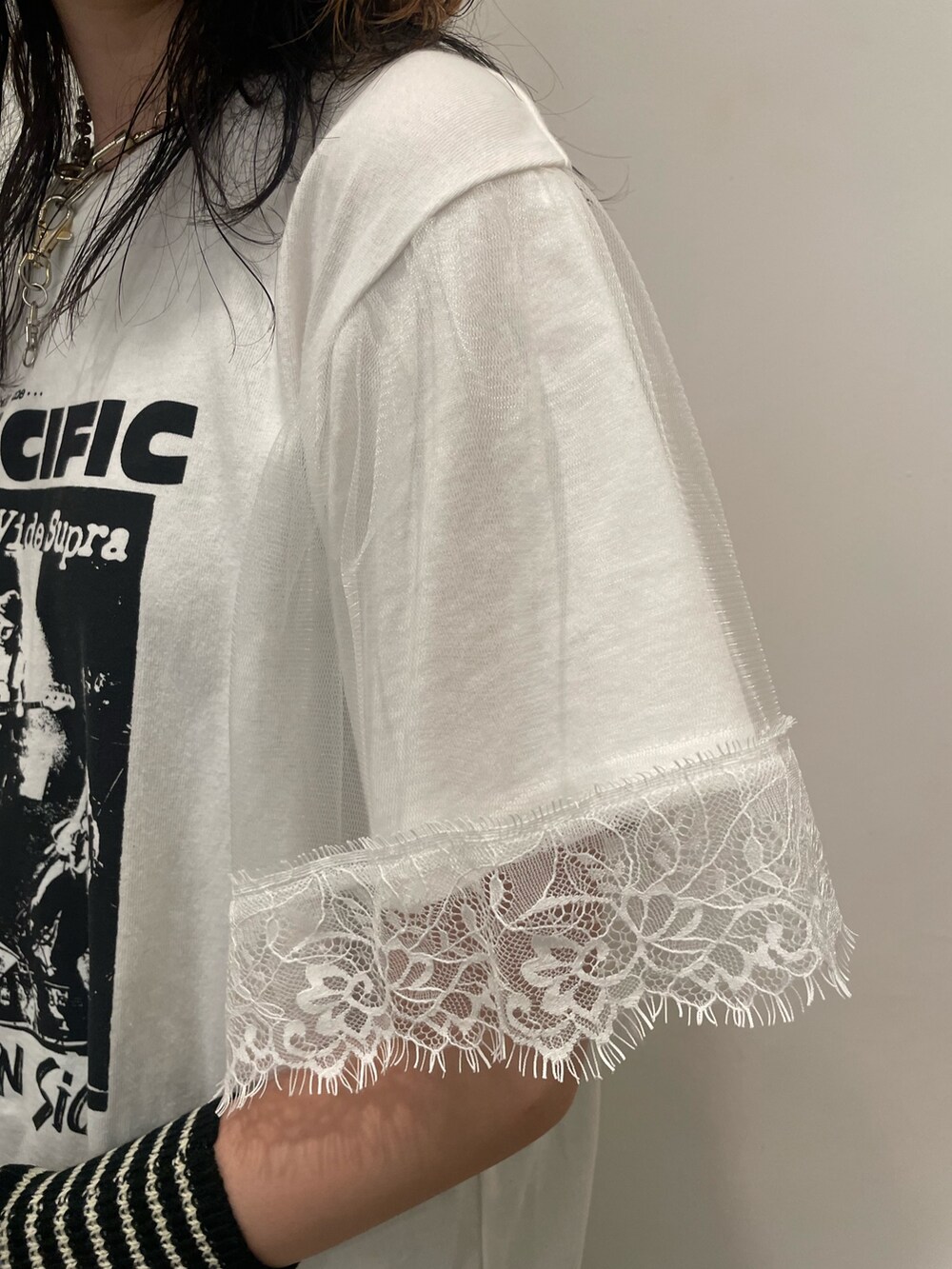 ホワイト系のTシャツ/カットソー、ブラック系のハンドバッグ、ブラック系のブーツを着用したレディースの夏コーディネートの6枚目の写真