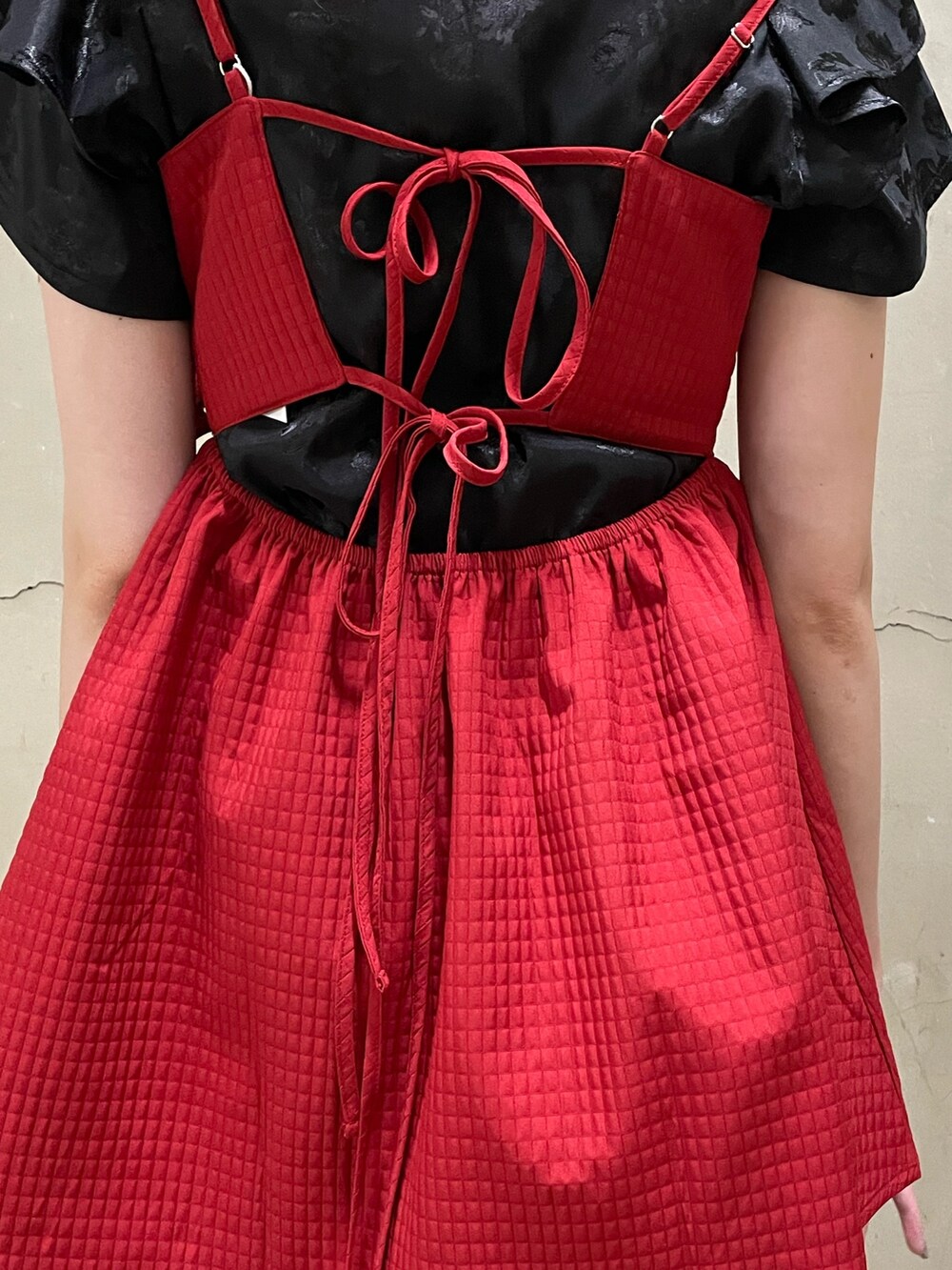 レッド系のキャミソール、ブラック系のシャツ/ブラウス、シルバー系のハンドバッグを着用したレディースの夏コーディネートの6枚目の写真