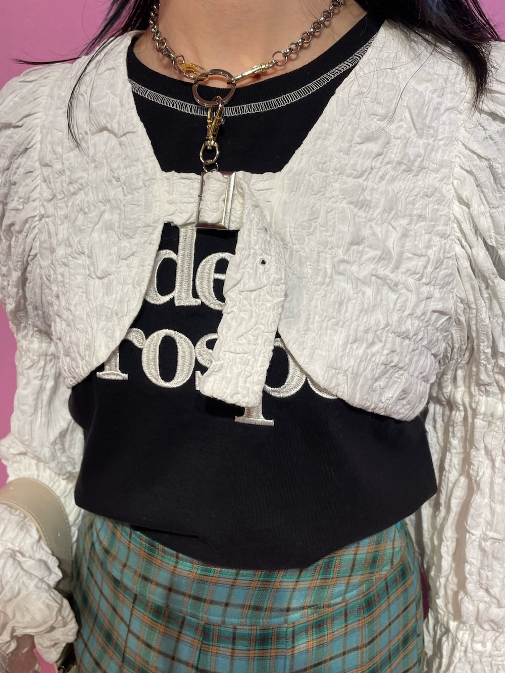 ブラック系のTシャツ/カットソー、ホワイト系のカーディガン/ボレロ、グリーン系のスカートを着用したレディースの冬コーディネートの6枚目の写真