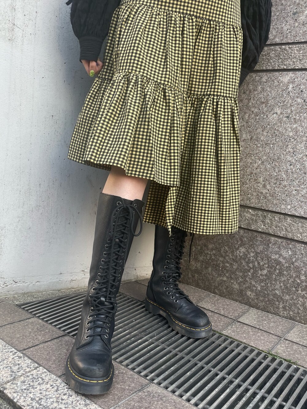 イエロー系のスカート、ブラック系のカーディガン/ボレロ、ブラック系のTシャツ/カットソーを着用したレディースの春コーディネートの7枚目の写真