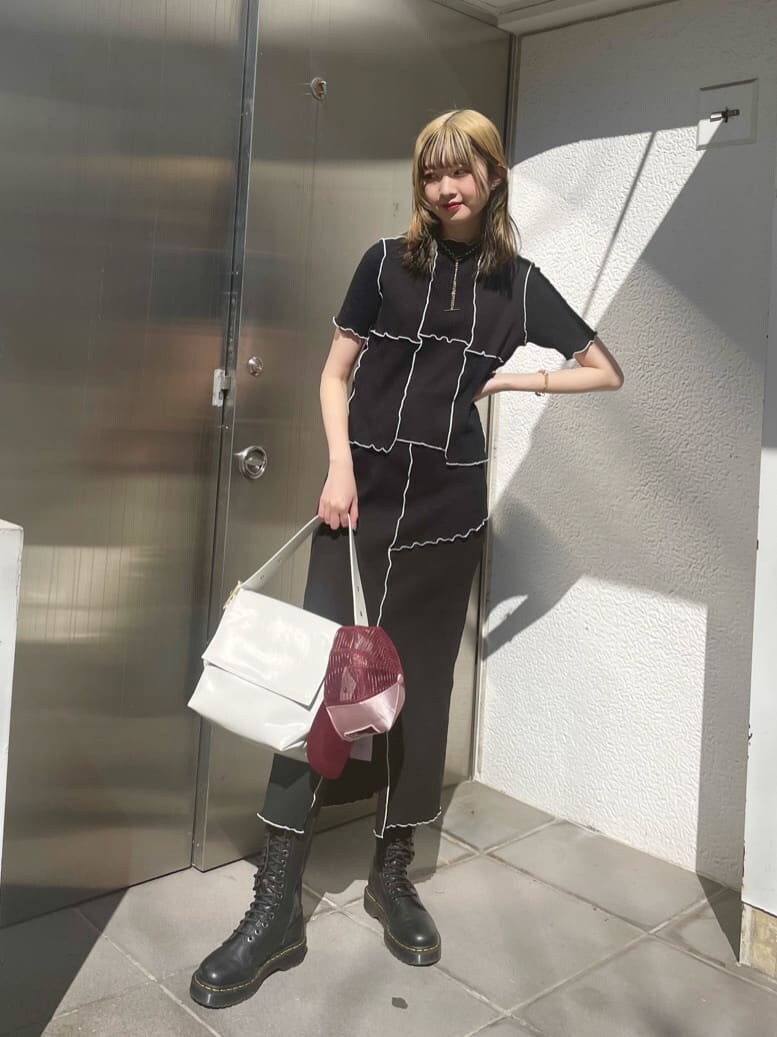 ブラック系のスカート、ブラック系のTシャツ/カットソー、シルバー系のネックレスを着用したレディースの春コーディネートの2枚目の写真