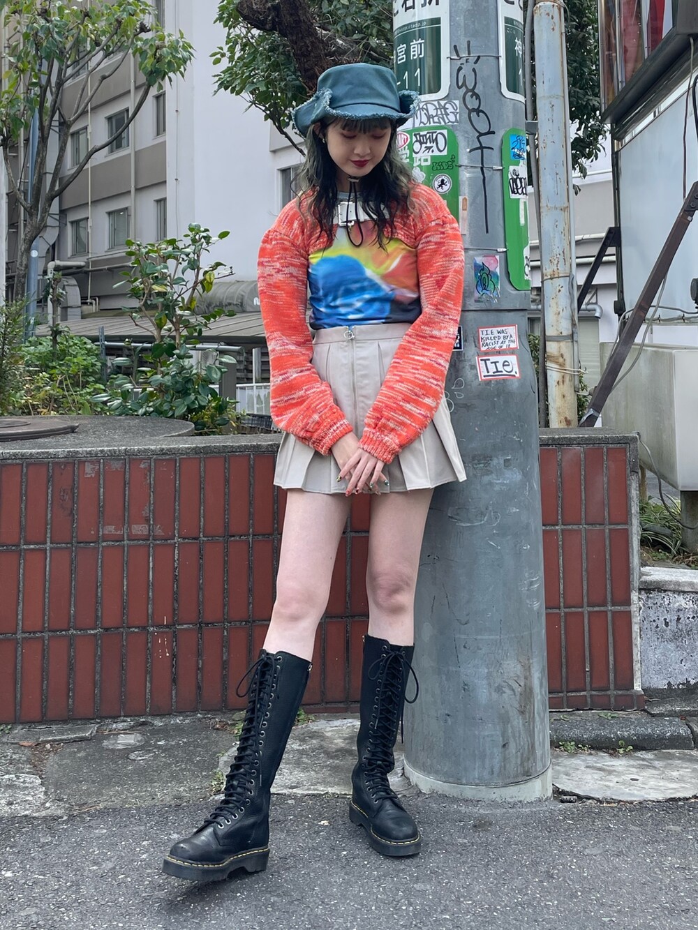 ブラック系のTシャツ/カットソー、オレンジ系のニット/セーター、ホワイト系のその他パンツを着用したレディースの冬コーディネートの2枚目の写真