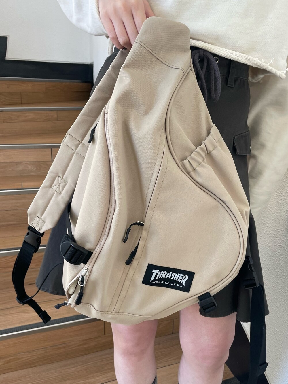 ホワイト系のパーカー、レッド系のブーツ、ブラック系のスカートを着用したレディースの春コーディネートの8枚目の写真