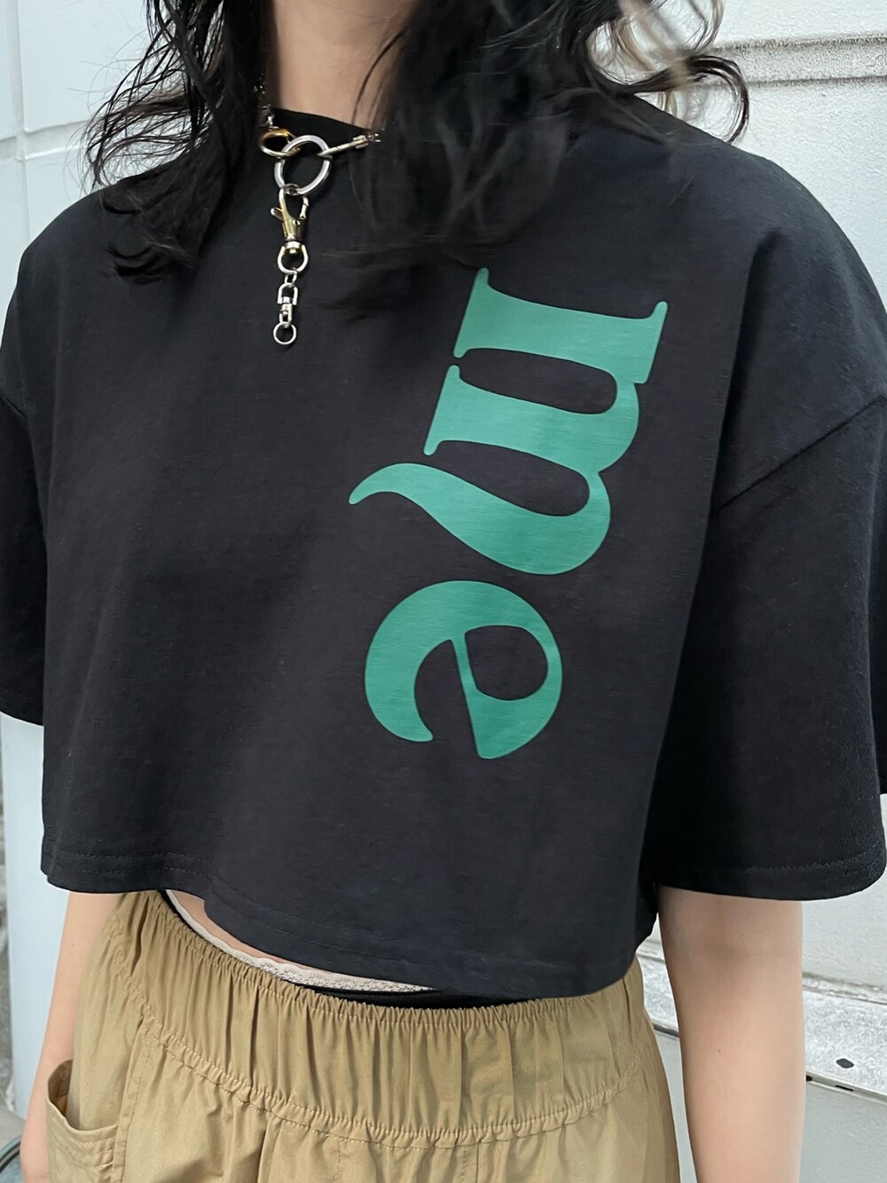 ベージュ系のカーゴパンツ、ブラック系のTシャツ/カットソー、ブラック系のブーツを着用したレディースの夏コーディネートの5枚目の写真