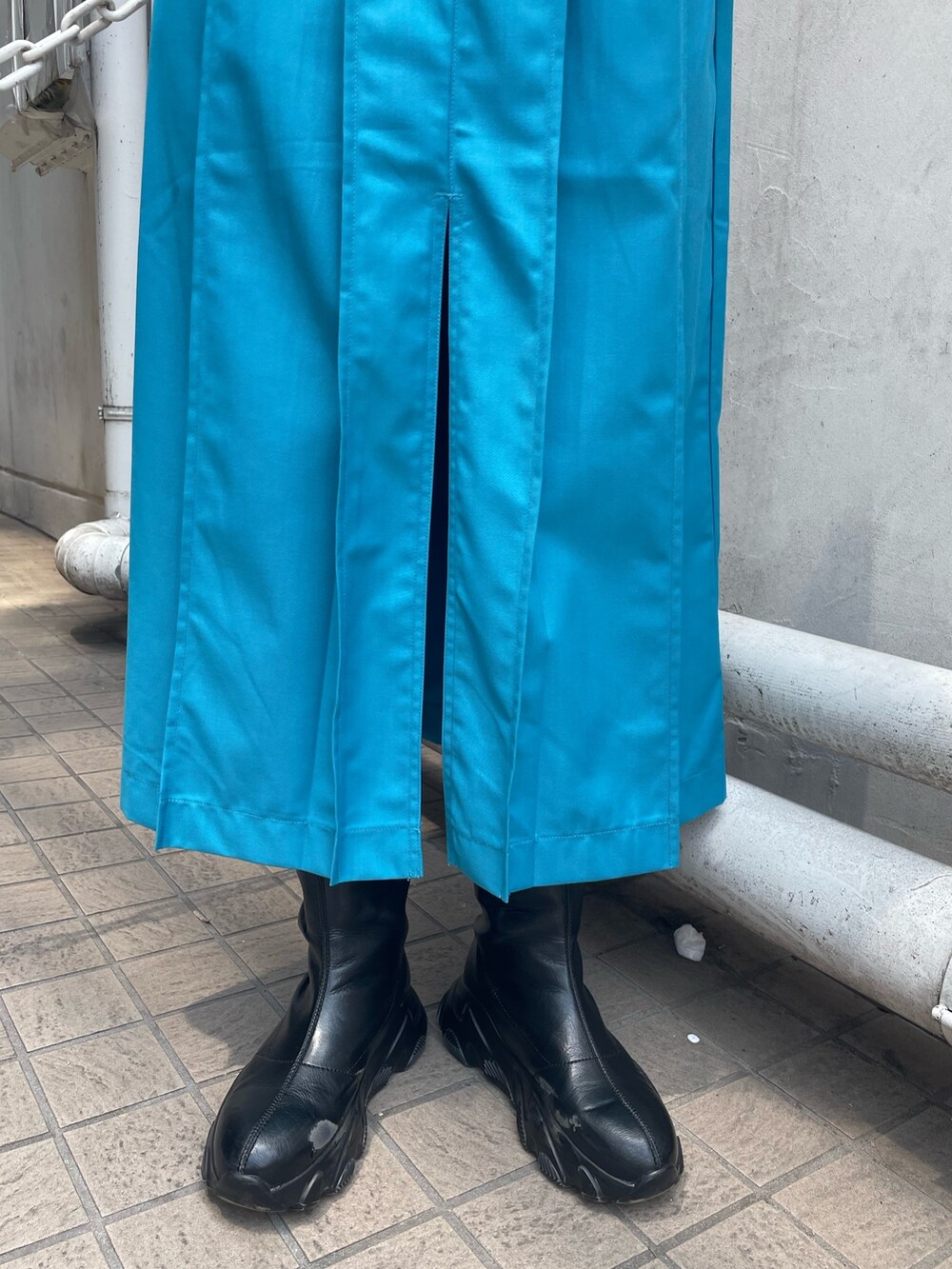 ホワイト系のTシャツ/カットソー、ブルー系のスカート、ブラック系のハンドバッグを着用したレディースの春コーディネートの7枚目の写真