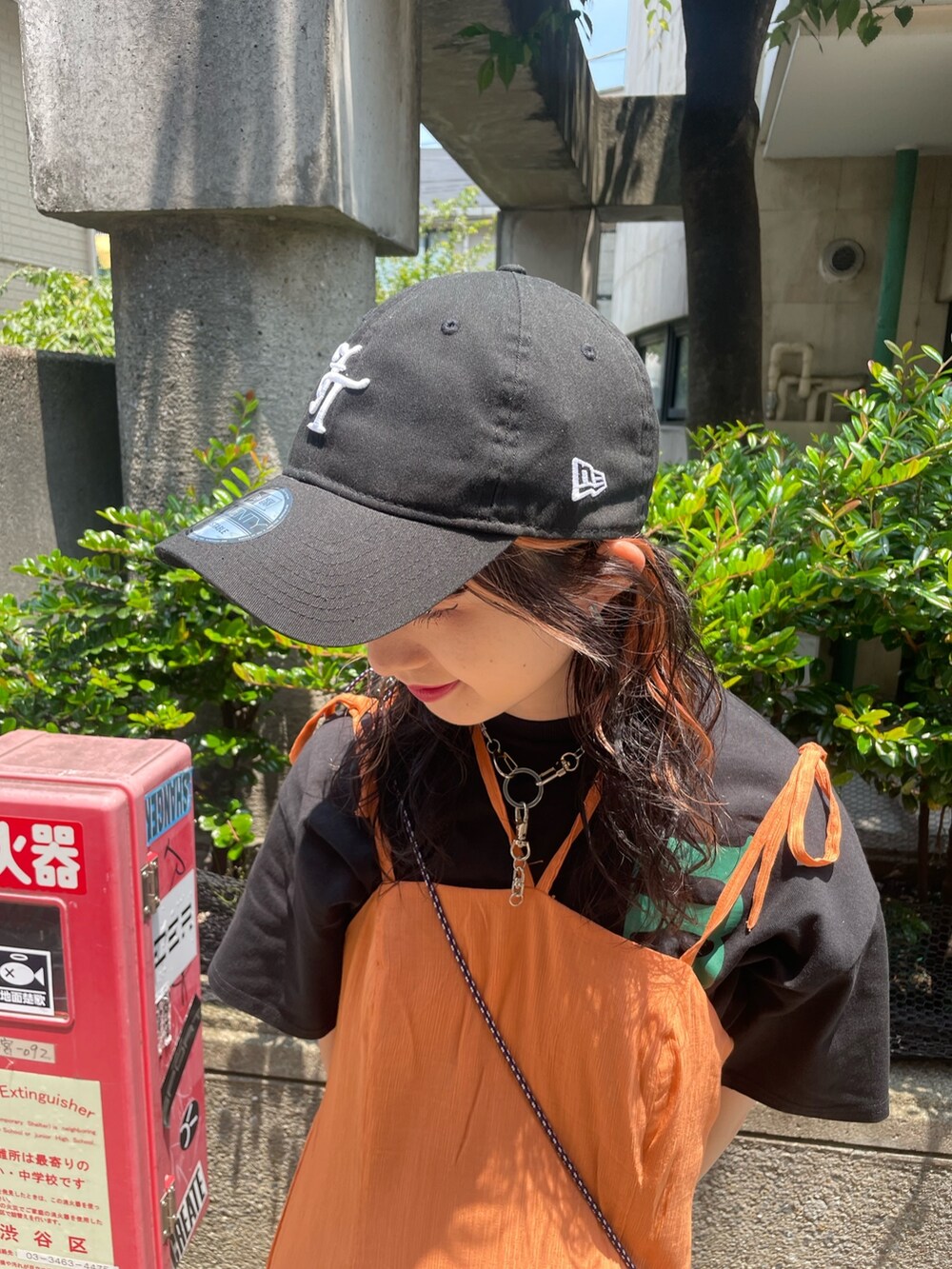 ブラック系のTシャツ/カットソー、オレンジ系のワンピース、ブラック系のショルダーバッグを着用したレディースの夏コーディネートの8枚目の写真