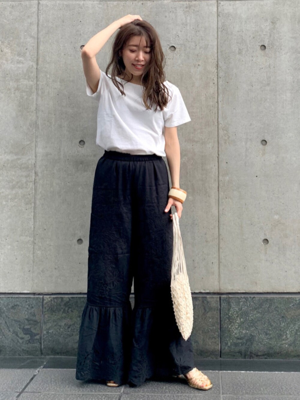 ホワイト系のTシャツ/カットソー、ブラック系のその他パンツ、その他のサンダルを着用したレディースの春コーディネートの3枚目の写真