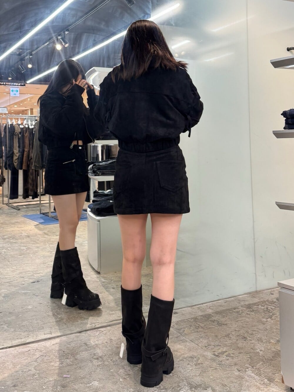 ブラック系のブーツ、ブラック系のブルゾン、ブラック系のスカートを着用したレディースの秋コーディネートの3枚目の写真