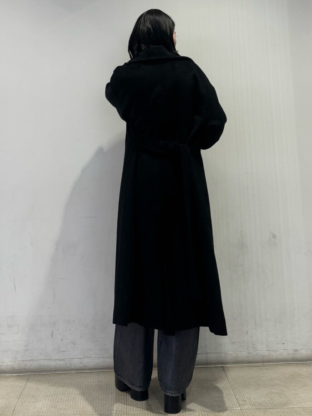 ブラック系のブーツ、シルバー系のニット/セーター、ブラック系のその他アウターを着用したレディースの冬コーディネートの4枚目の写真