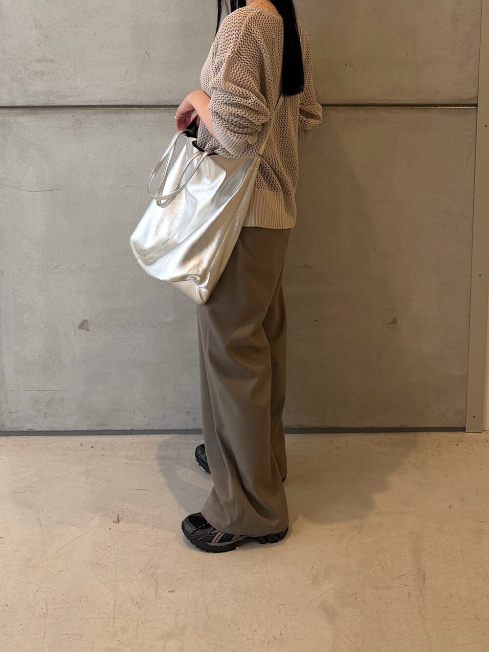 グレー系のニット/セーター、グレー系のその他パンツ、ブラック系のスニーカーを着用したレディースの春コーディネートの4枚目の写真