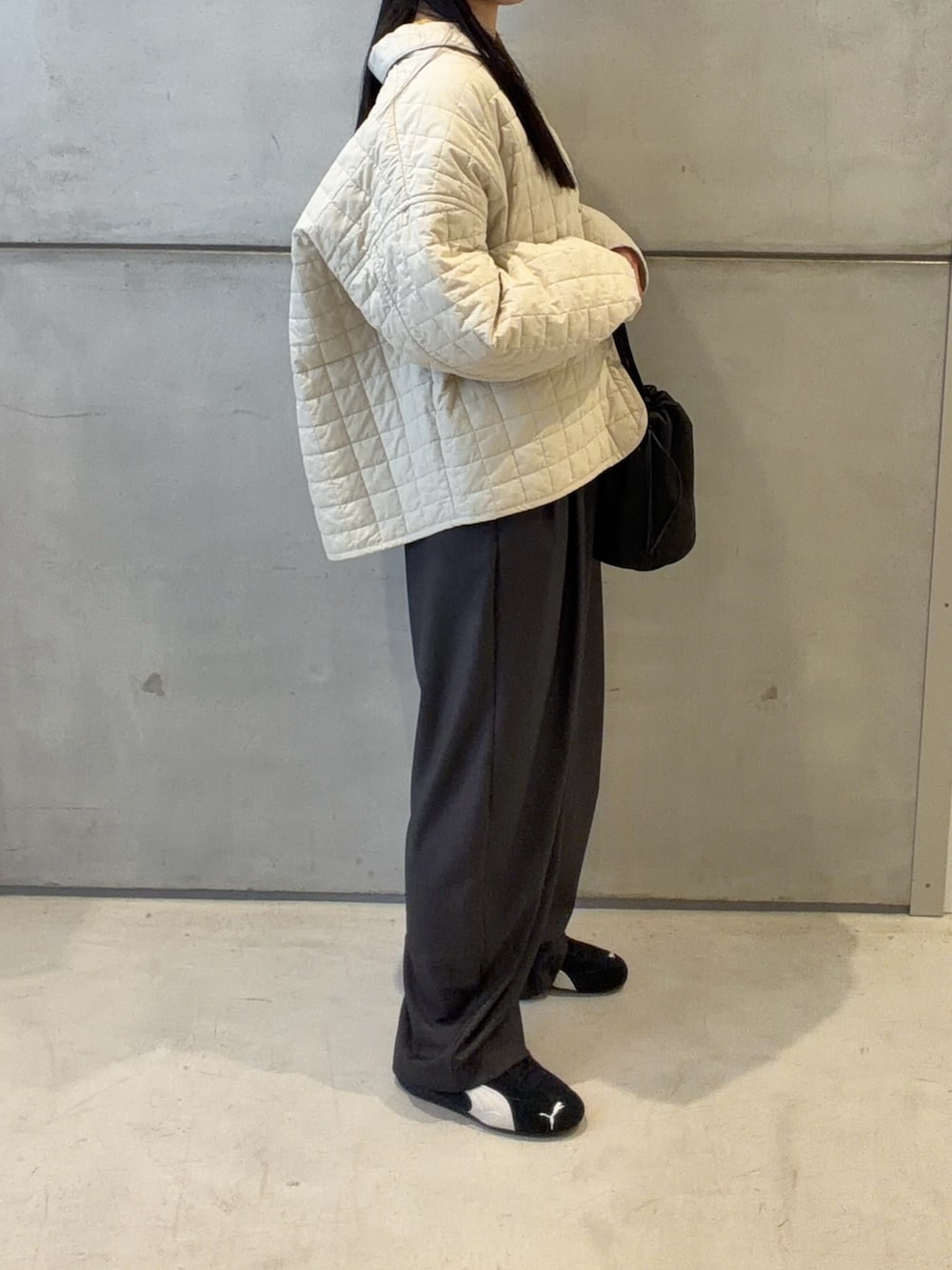 ホワイト系のダウンジャケット/コート、グレー系のその他パンツ、ブラック系のショルダーバッグを着用したレディースの春コーディネートの3枚目の写真