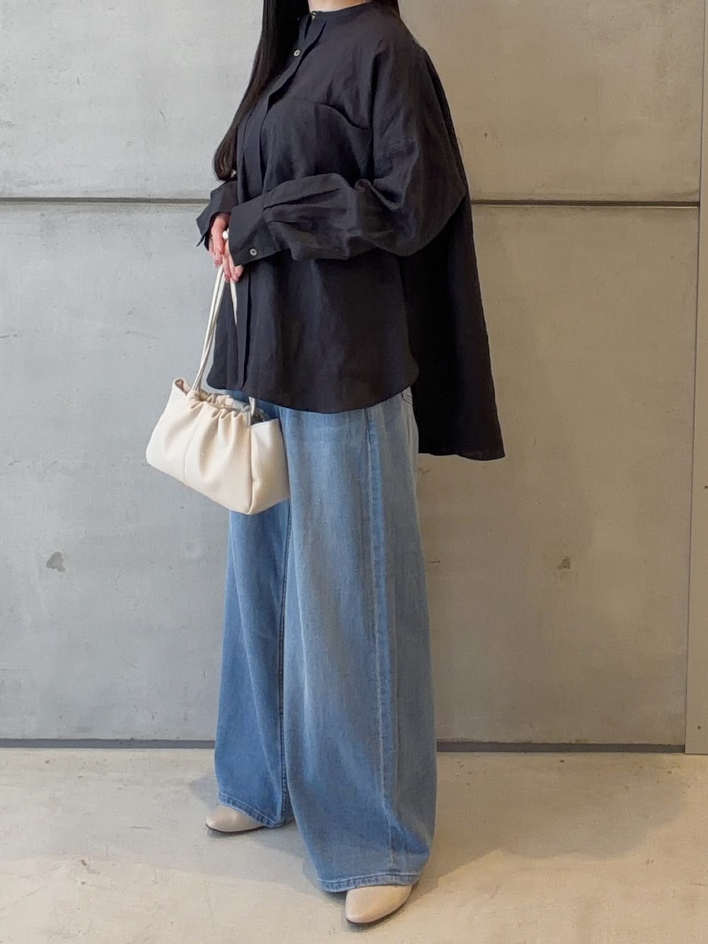 ブルー系のシャツ/ブラウス、ブルー系のデニムパンツ、ホワイト系のショルダーバッグを着用したレディースの春コーディネートの3枚目の写真