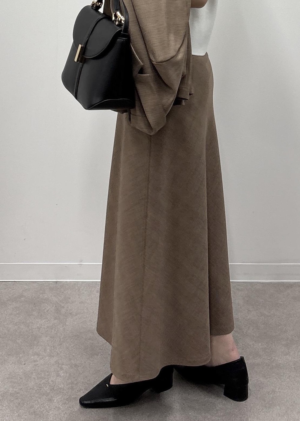 ブラウン系のスカート、ホワイト系のカーディガン/ボレロ、ブラウン系のテーラードジャケットを着用したレディースの春コーディネートの7枚目の写真