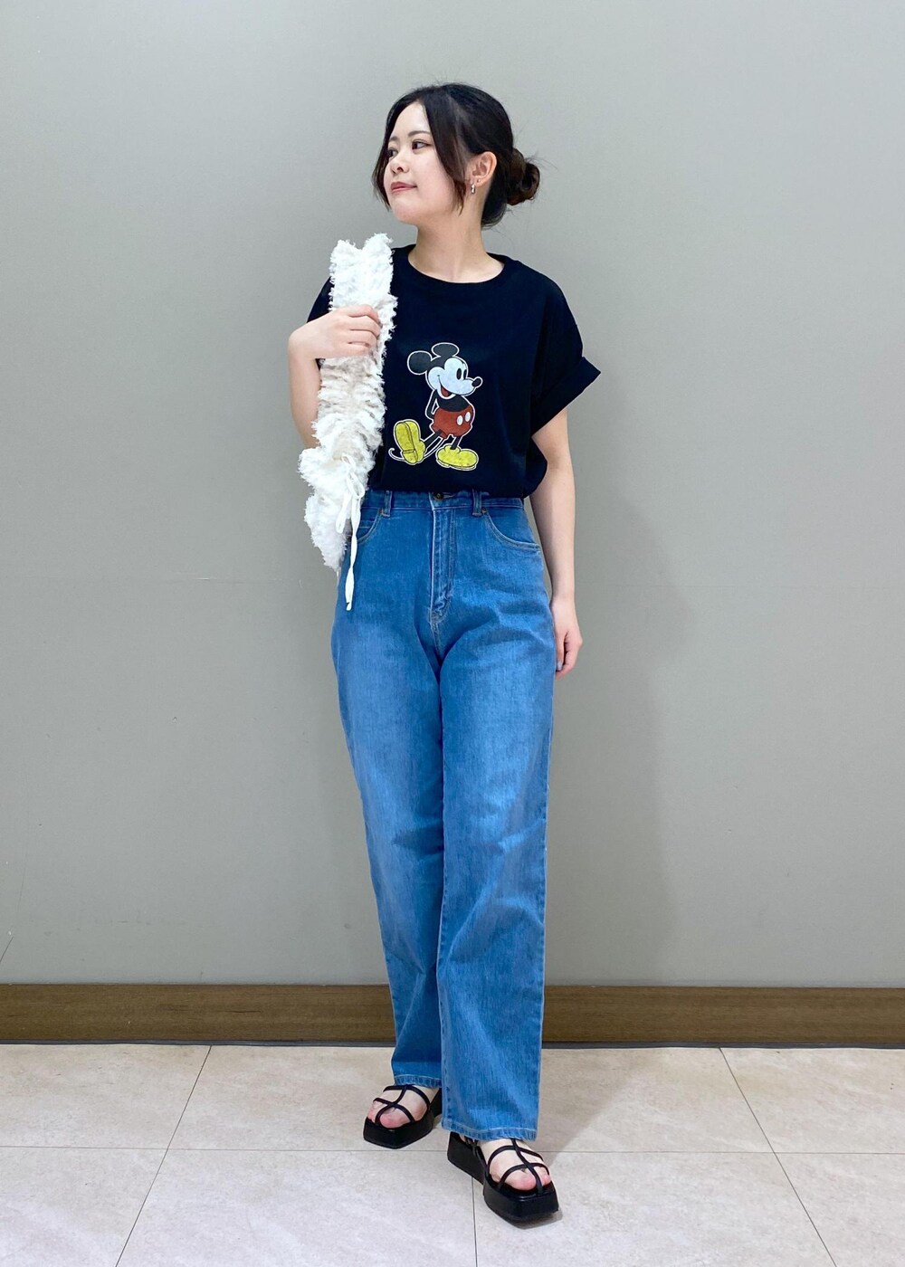 ブラック系のサンダル、ブラック系のTシャツ/カットソー、ホワイト系のショルダーバッグを着用したレディースの夏コーディネートの2枚目の写真