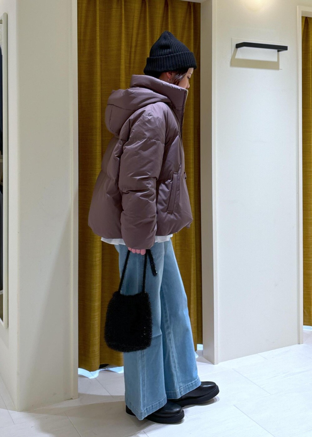 ブルー系のデニムパンツ、ホワイト系のシャツ/ブラウス、ブラック系のブーツを着用したレディースの冬コーディネートの2枚目の写真