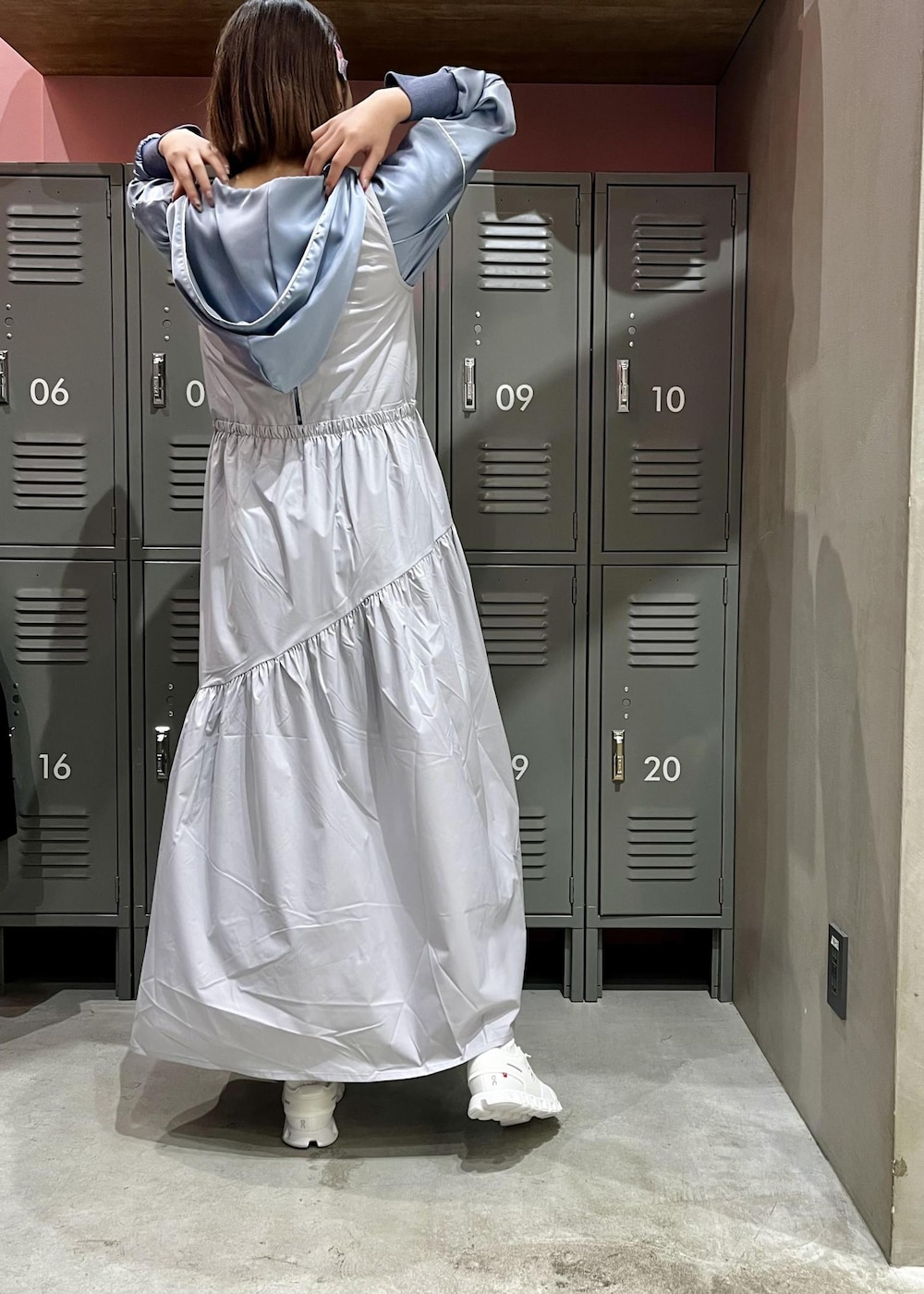 シルバー系のモッズコート、ホワイト系のスニーカー、グレー系のワンピースを着用したレディースの冬コーディネートの3枚目の写真