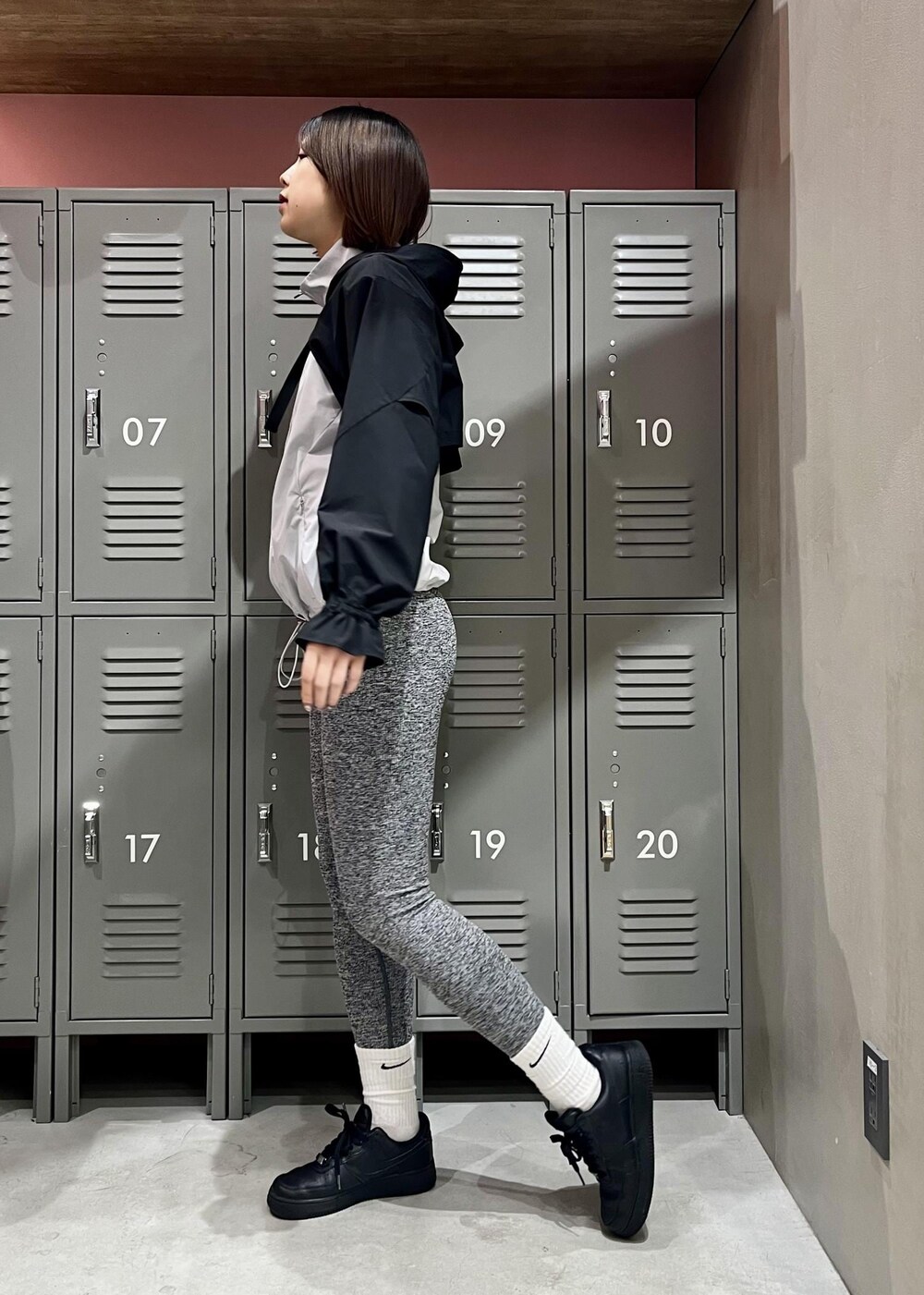 グレー系のブルゾン、ブラック系のスニーカー、グレー系のレギンス/スパッツを着用したレディースの春コーディネートの2枚目の写真