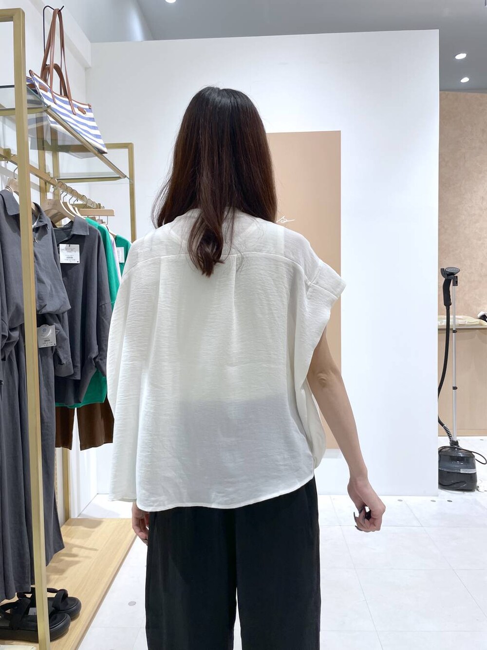 ブラック系のその他パンツ、ホワイト系のTシャツ/カットソー、ブラック系のハンドバッグを着用したレディースの夏コーディネートの6枚目の写真