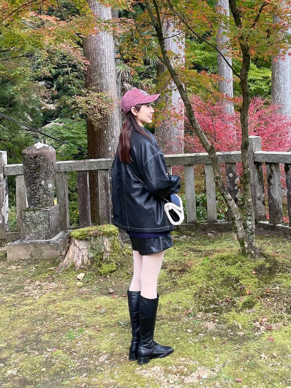 ブラック系のブルゾン、ブルー系のニット/セーター、ブラック系のショルダーバッグを着用したレディースの冬コーディネートの2枚目の写真