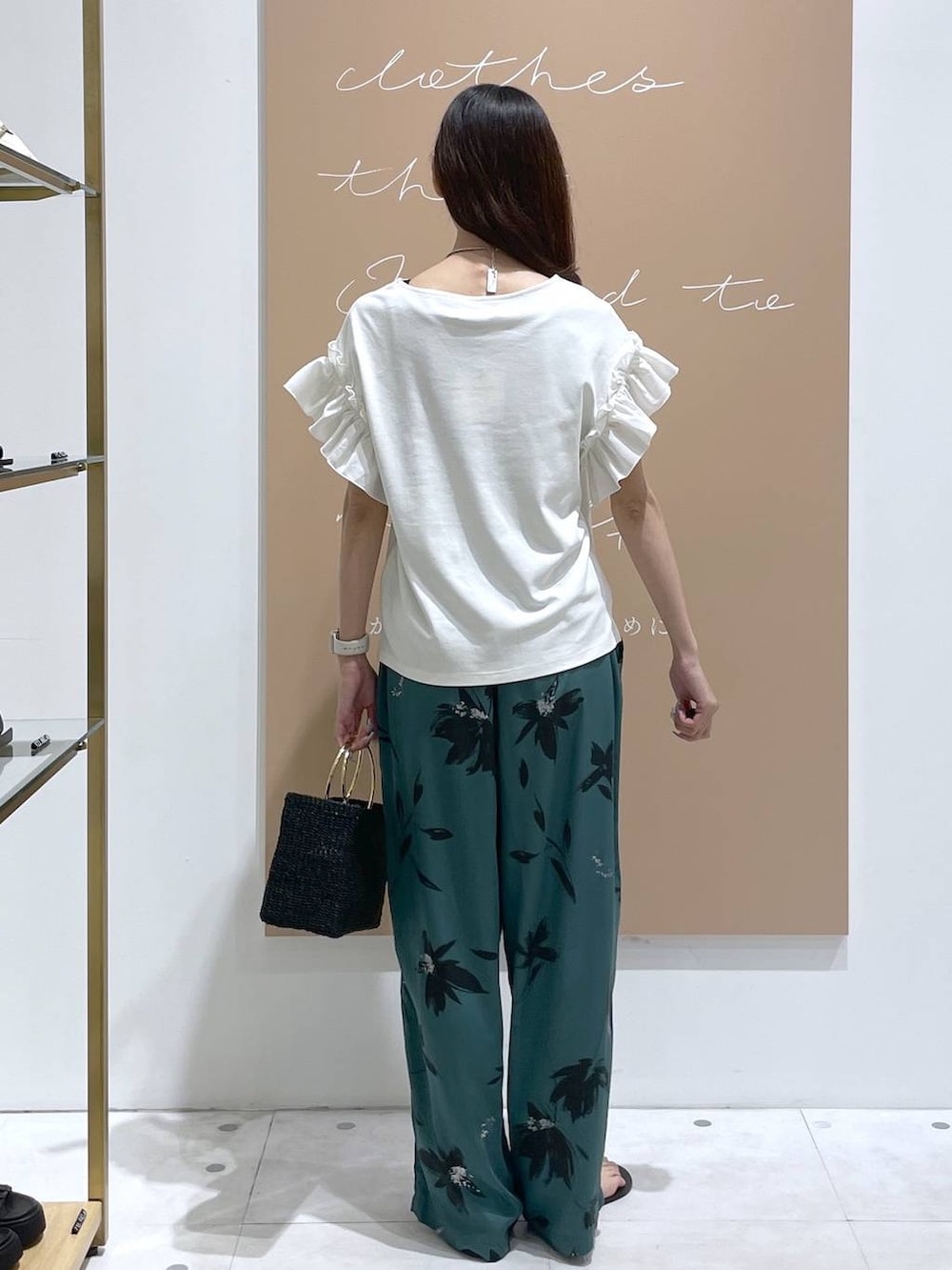 グリーン系のその他パンツ、ブラック系のトートバッグ、ホワイト系のTシャツ/カットソーを着用したレディースの夏コーディネートの3枚目の写真