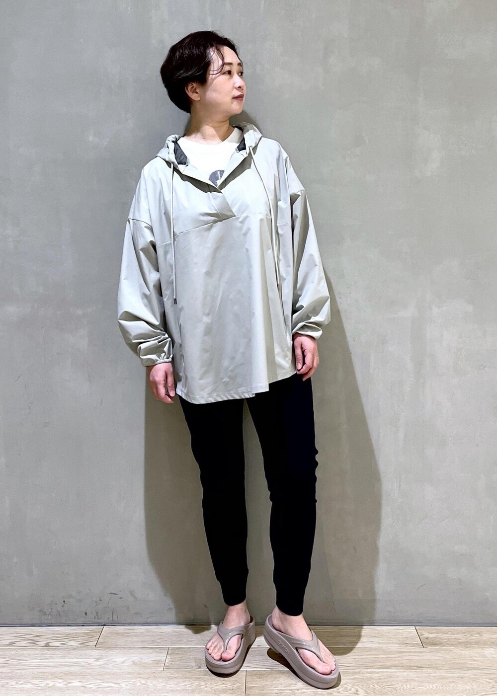 ベージュ系のサンダル、グリーン系のパーカーを着用したレディースの春コーディネートの4枚目の写真