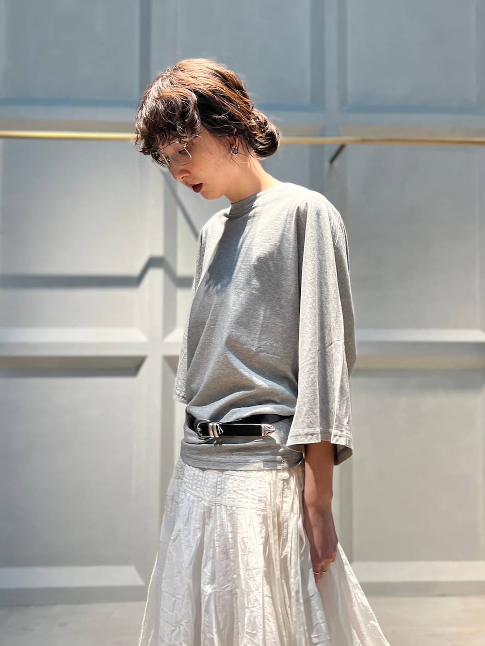 ホワイト系のスカート、グレー系のTシャツ/カットソー、シルバー系のバングル/リストバンドを着用したレディースの夏コーディネートの6枚目の写真