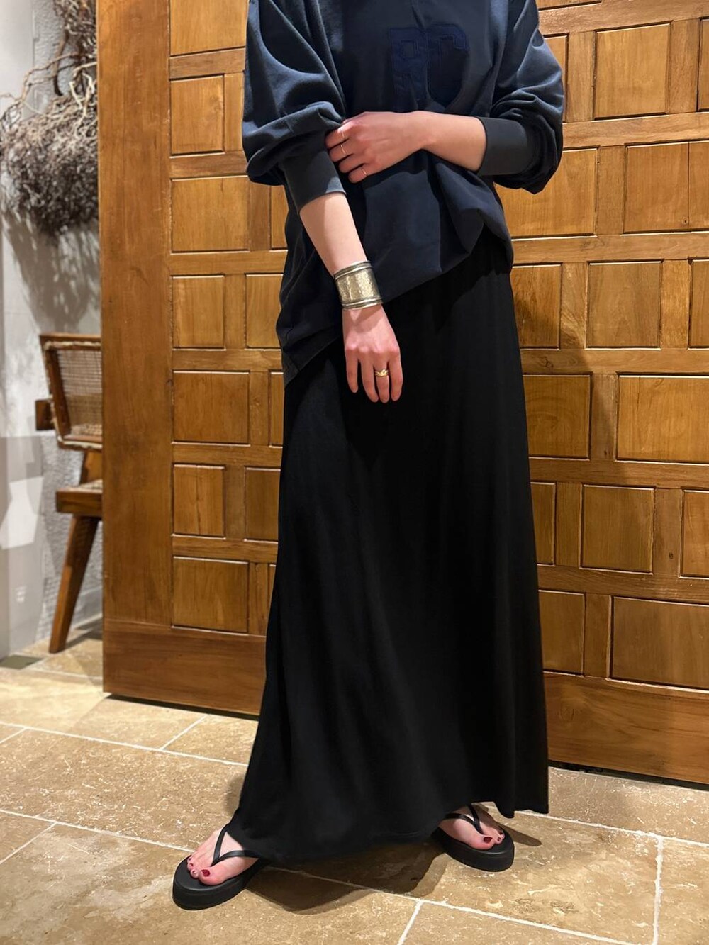 ブラック系のスカート、ブルー系のシャツ/ブラウス、ゴールド系のチョーカーを着用したレディースの春コーディネートの6枚目の写真