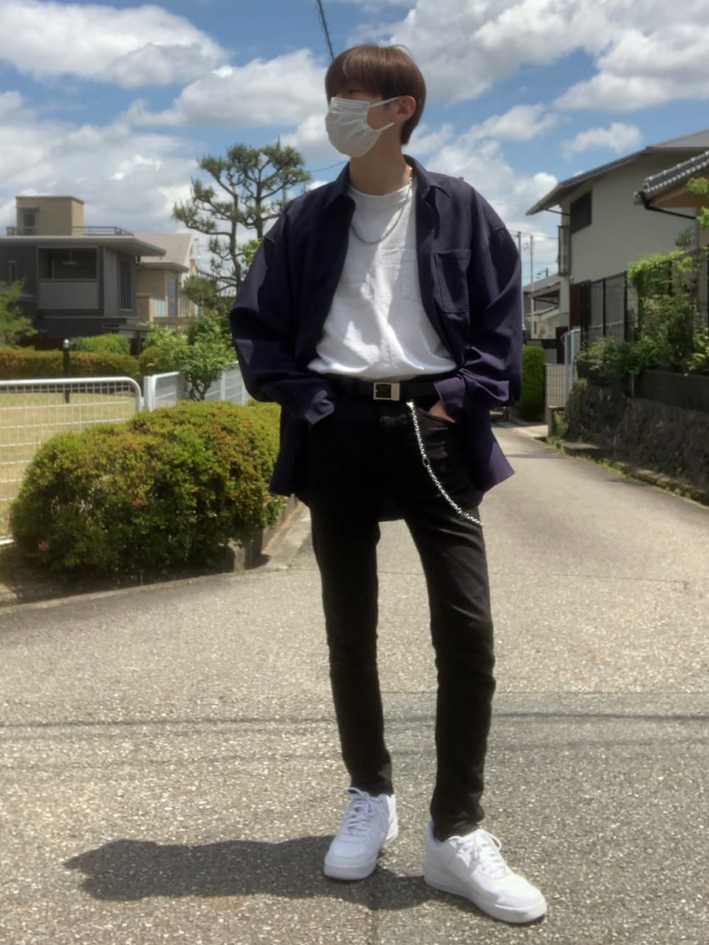 ホワイト系のスニーカー、ホワイト系のTシャツ/カットソー、ブラック系のデニムパンツを着用したメンズの春コーディネートの2枚目の写真