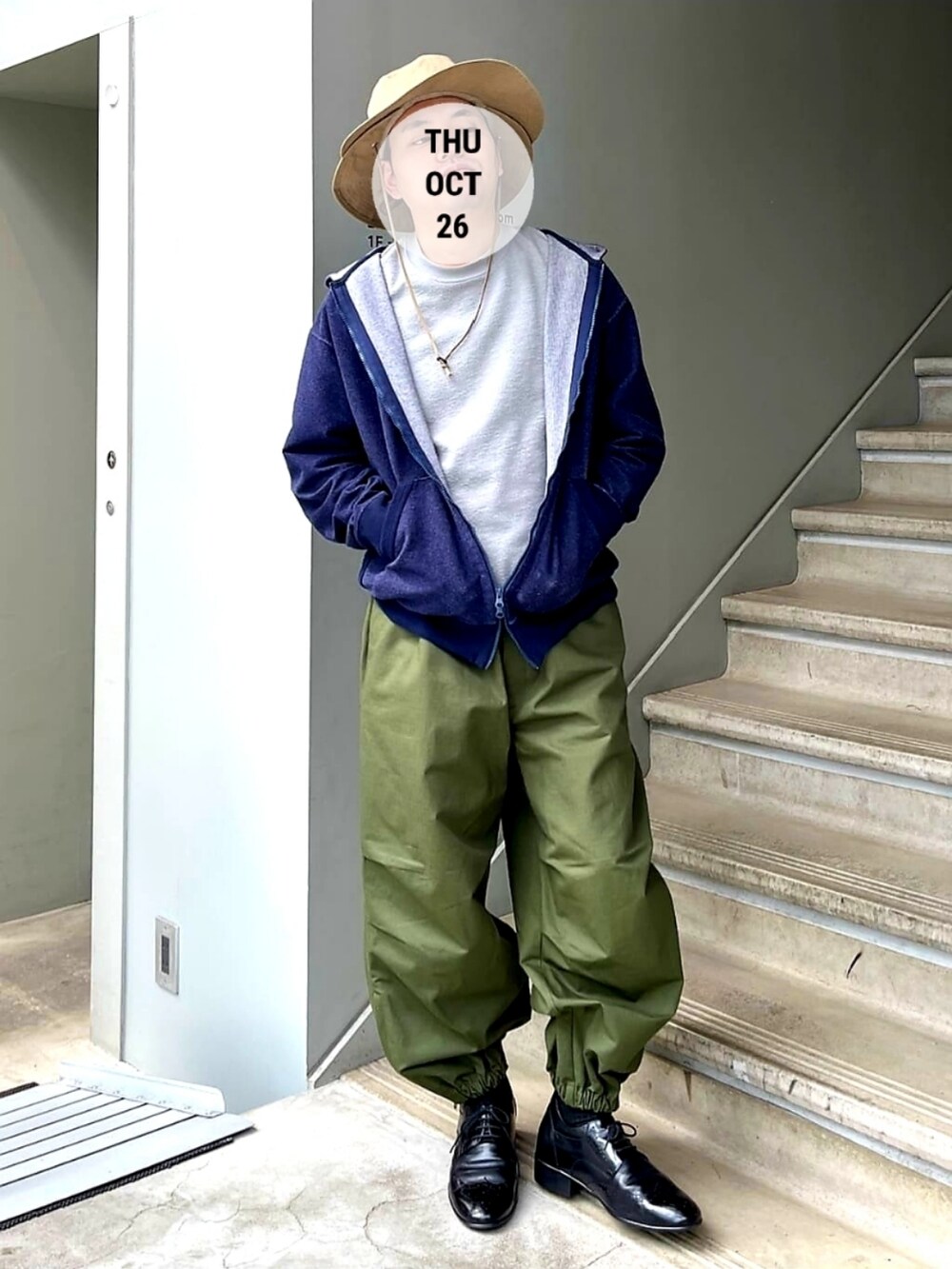 グレー系のTシャツ/カットソー、グリーン系のカーゴパンツ、ブルー系のパーカーを着用したメンズの秋コーディネートの2枚目の写真