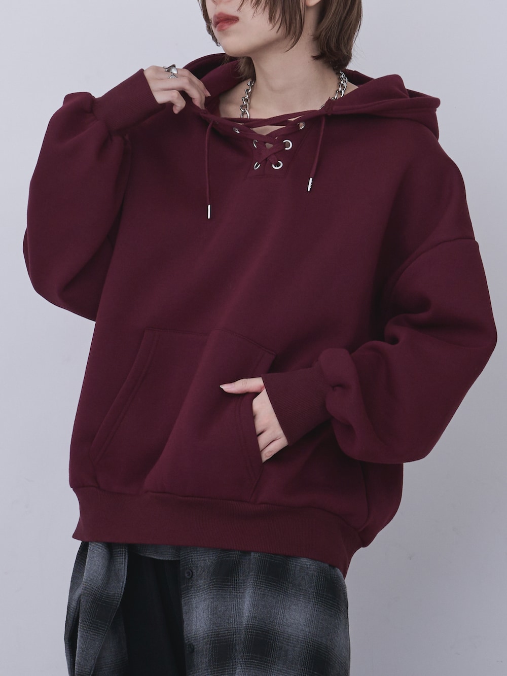 ブラック系のブルゾン、レッド系のパーカー、ブラック系のパンツを着用したレディースの冬コーディネートの4枚目の写真