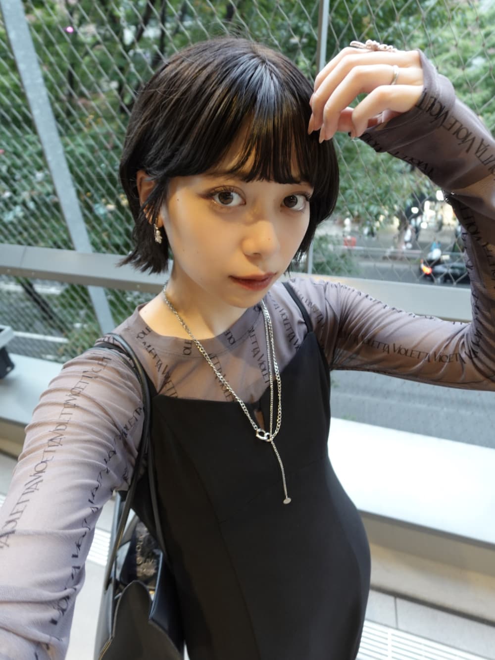 ブラック系のパンプス、ブラック系のドレス、グレー系のTシャツ/カットソーを着用したレディースの秋コーディネートの3枚目の写真