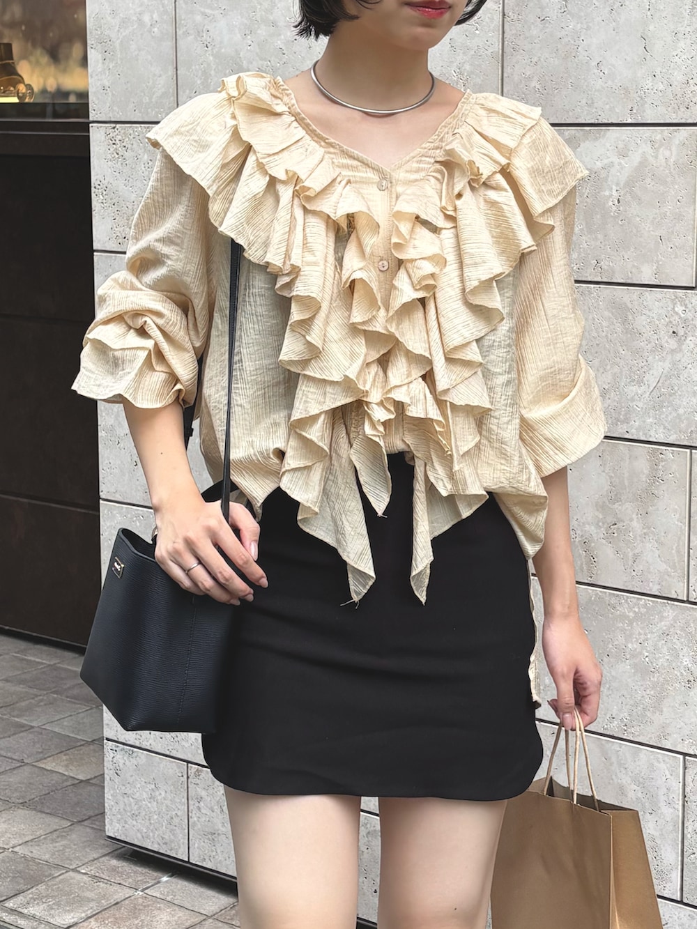 イエロー系のシャツ/ブラウス、ブラック系のスカート、ブラック系のローファーを着用したレディースの秋コーディネートの4枚目の写真