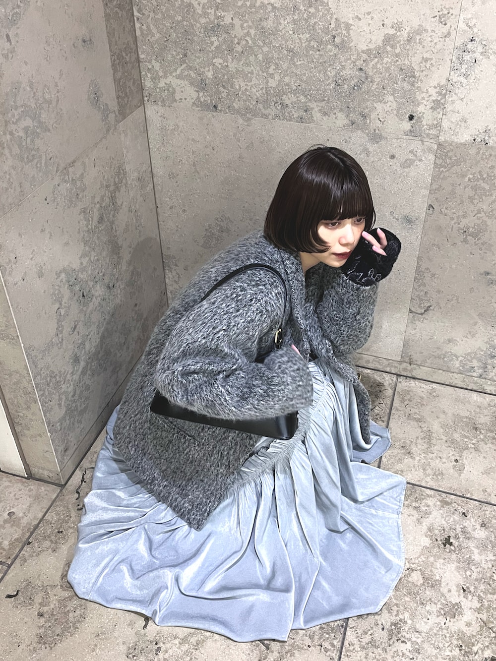 グレー系のテーラードジャケット、ブラック系のワンピース、ブラック系のショルダーバッグを着用したレディースの冬コーディネートの3枚目の写真